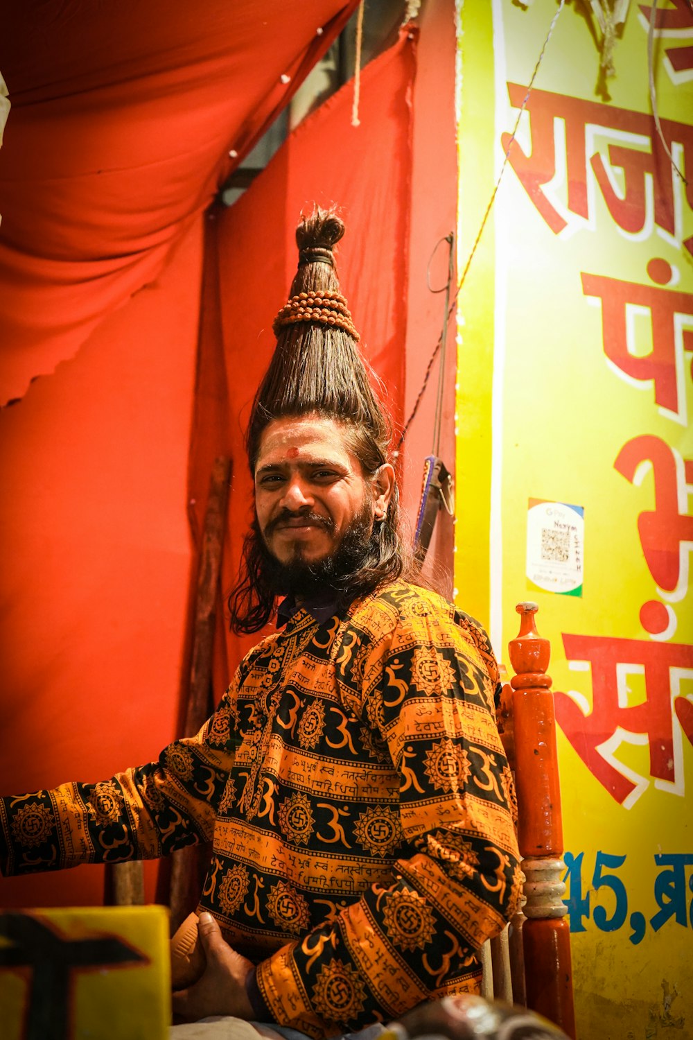 a man sitting in a chair in front of a sign