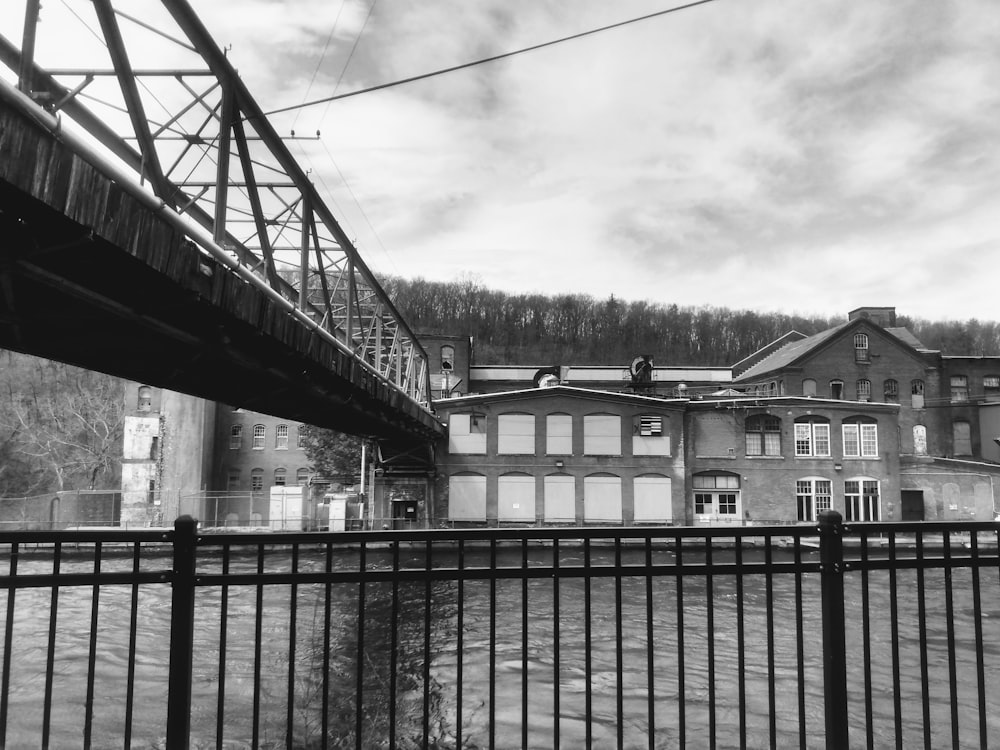 a black and white photo of a building and a bridge