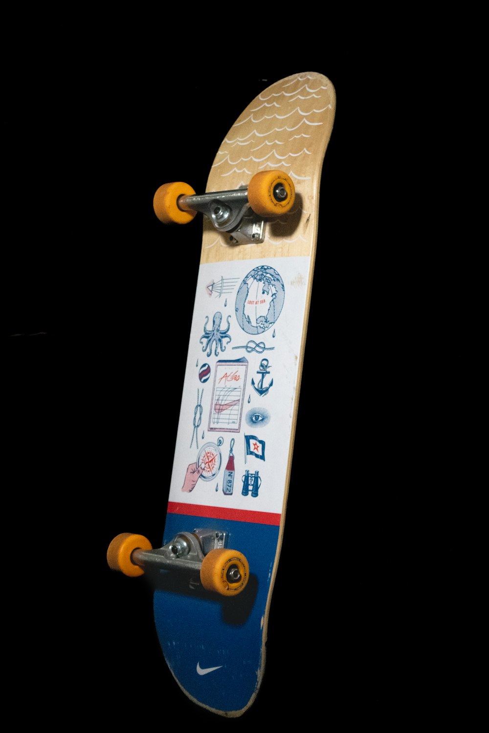 a skateboard with a lot of stickers on it