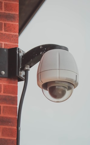 a security camera attached to a brick wall