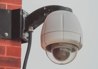 a security camera attached to a brick wall