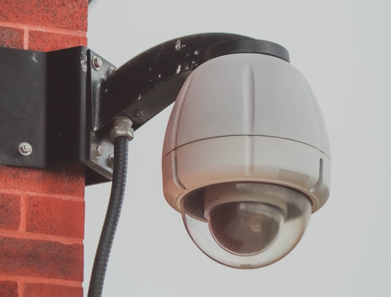 a security camera attached to a brick wall