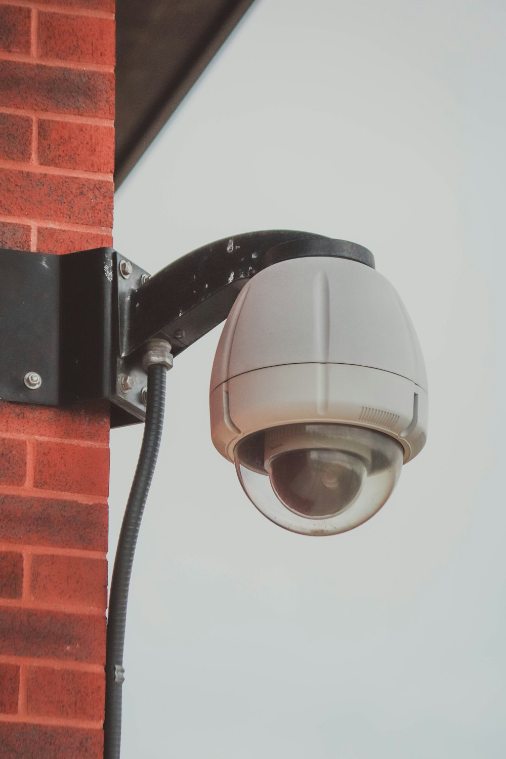 a security camera attached to a brick wall