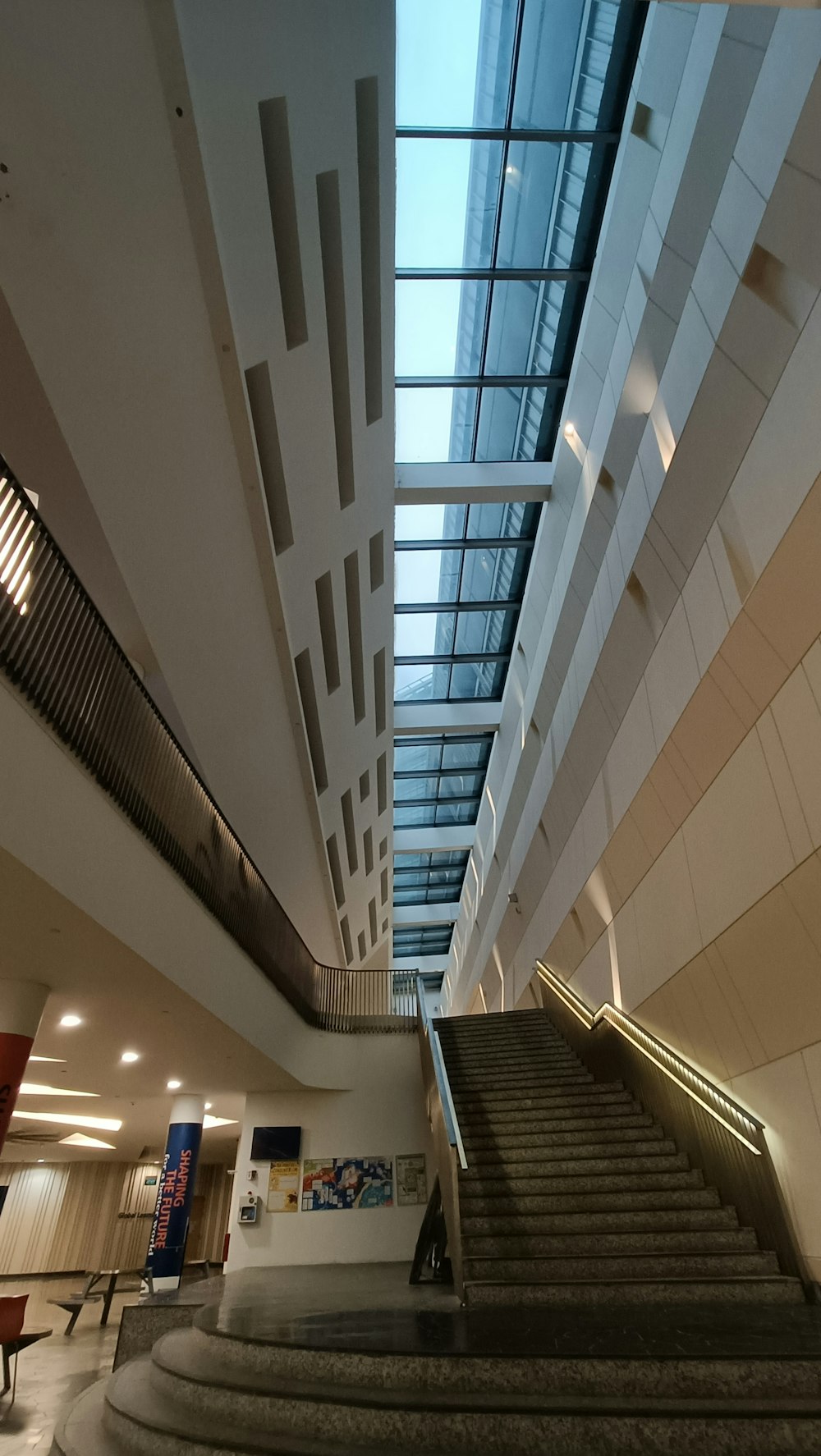 a staircase leading up to a skylight in a building