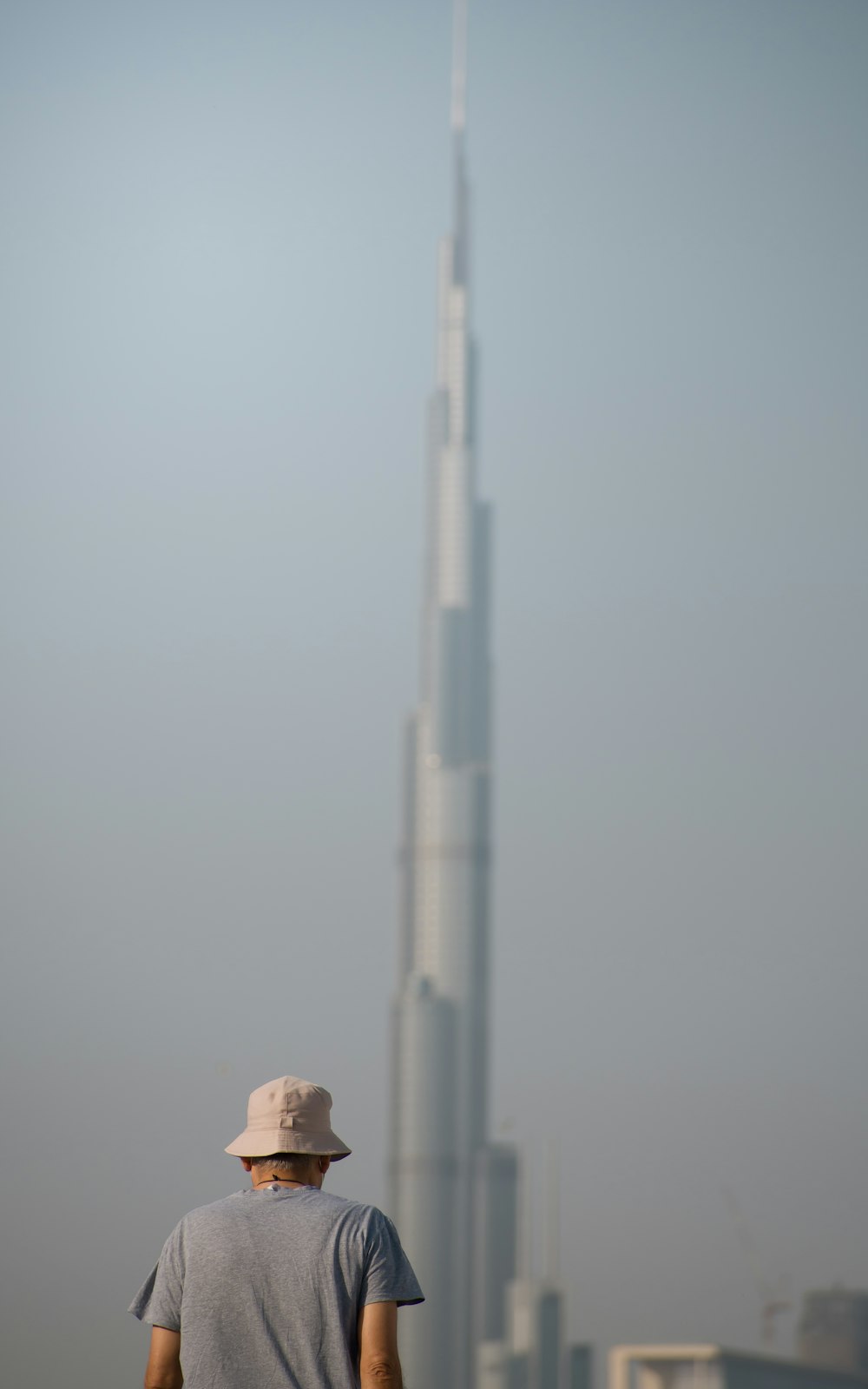 a man standing in front of a tall building