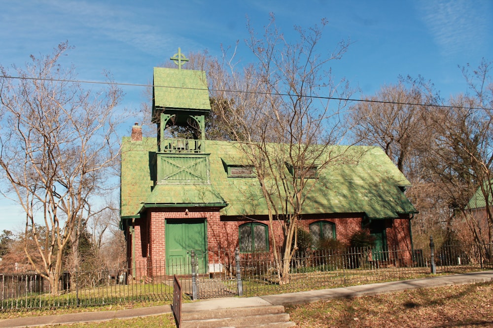 a church with a green steeple and a bell tower