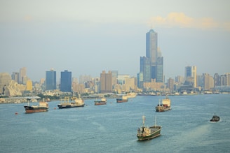 A dynamic skyline of Lagos with bustling trade ships in the harbor at sunset.