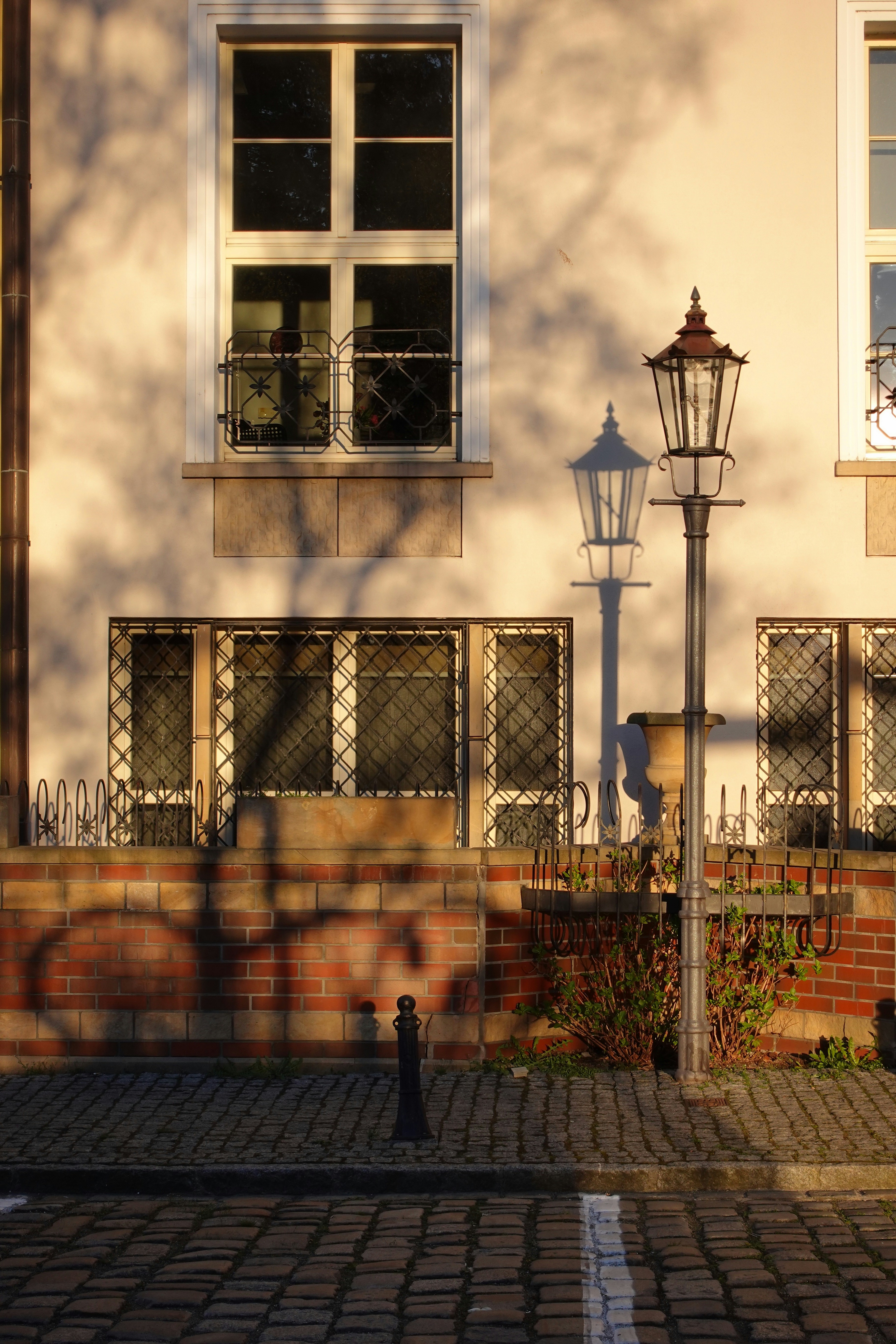 a person standing in front of a building next to a street light
