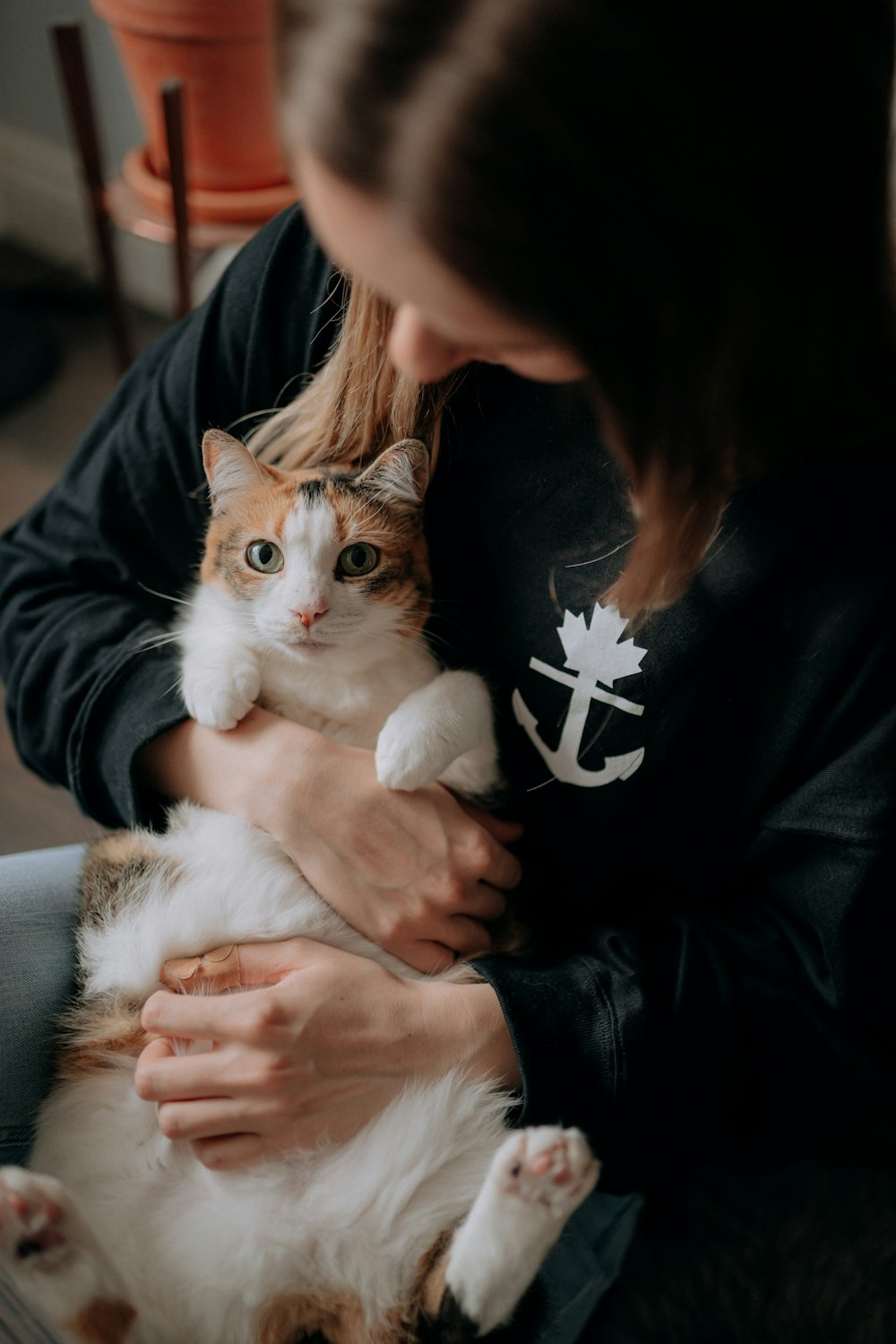 a woman holding a cat in her arms