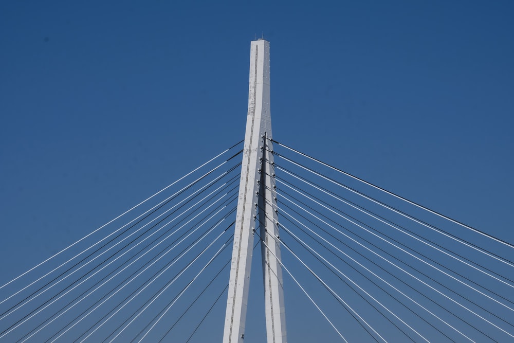 a very tall white bridge with a very tall tower