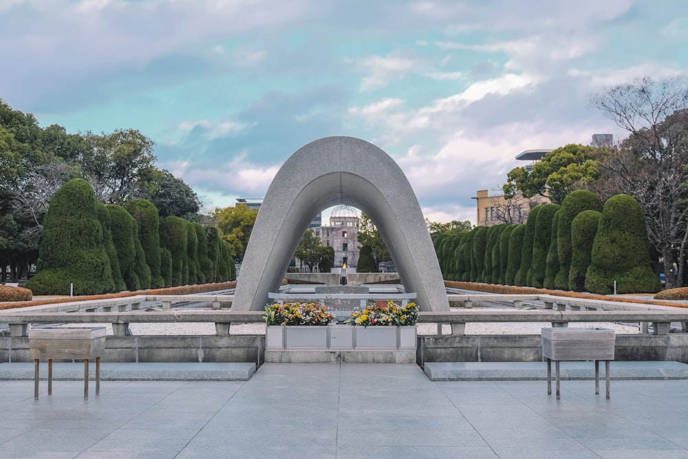 a large monument with benches in front of it