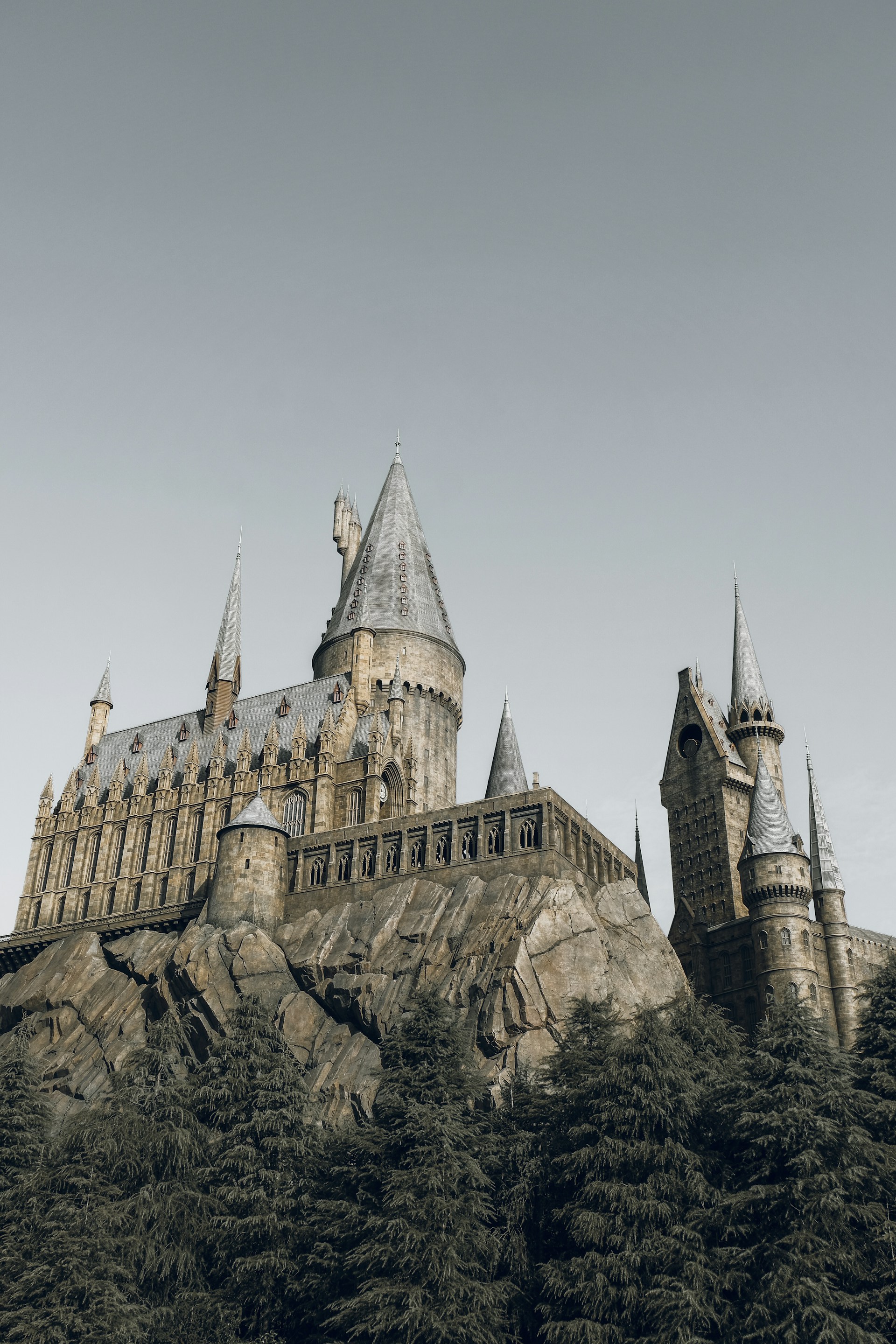a castle on a hill with a sky background