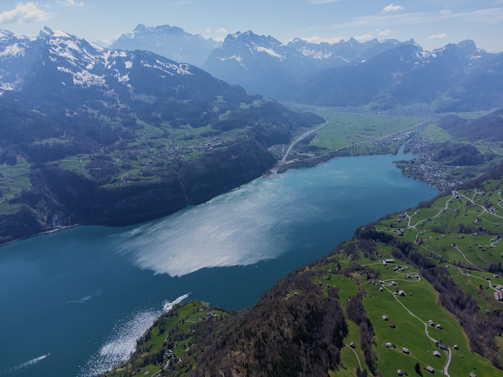 an aerial view of a lake surrounded by mountains