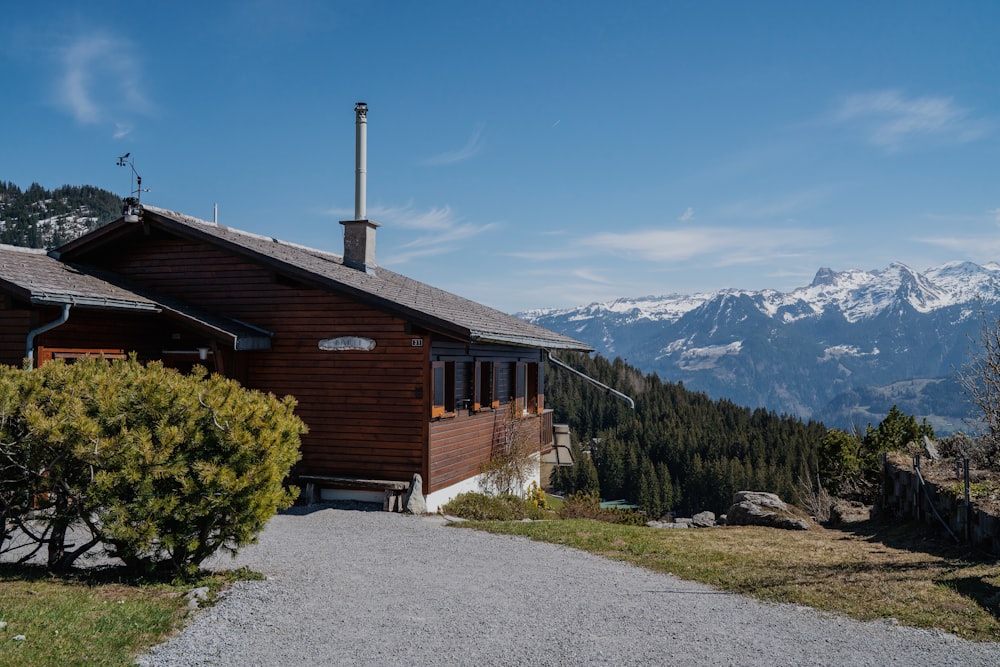 a house on a hill with mountains in the background