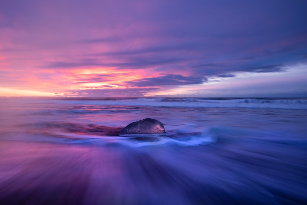 a rock in the middle of a body of water