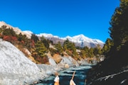 a couple of people standing on top of a river