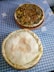 two pies sitting on top of a blue table cloth