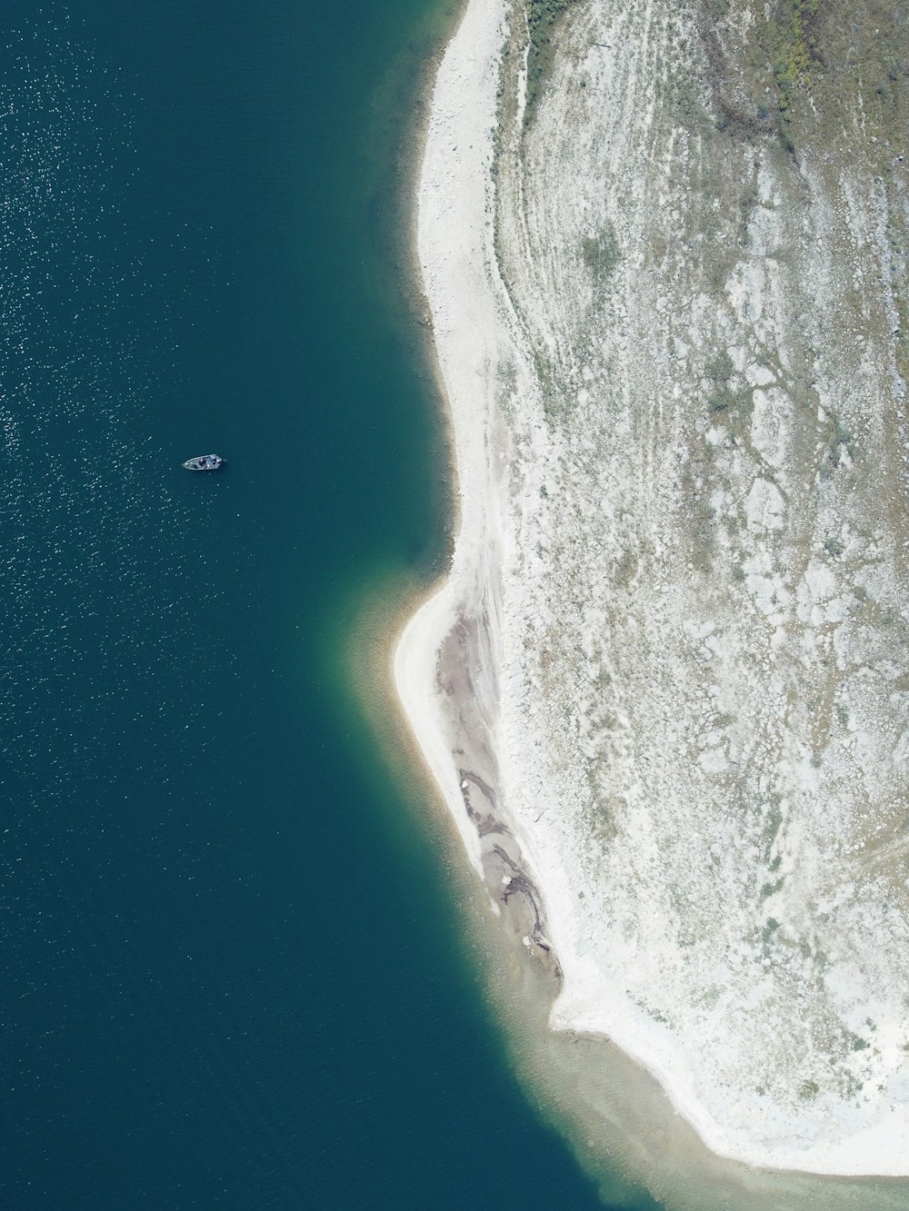 an aerial view of a boat in a body of water