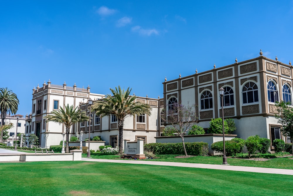 a large building with palm trees in front of it