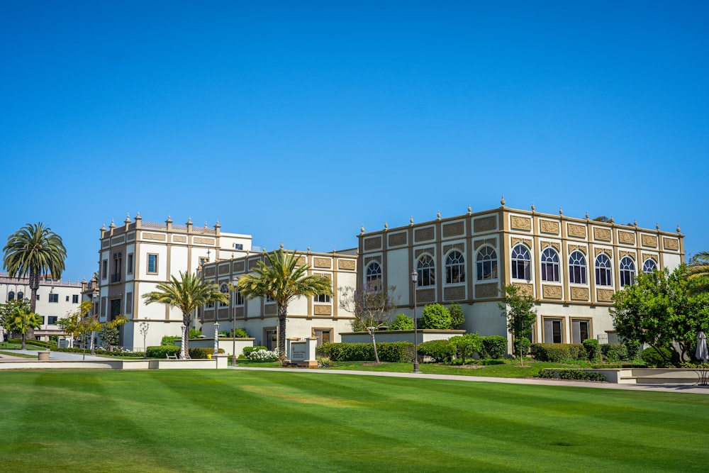 a large building with palm trees in front of it