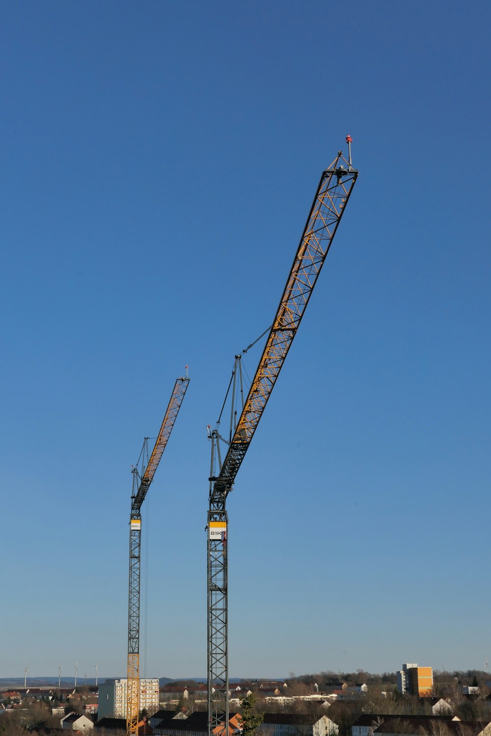a couple of cranes that are next to each other