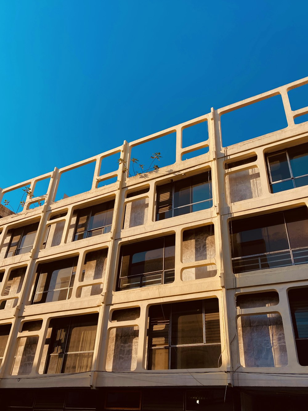 a tall building with lots of windows and balconies