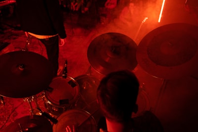 a man playing drums in a dark room