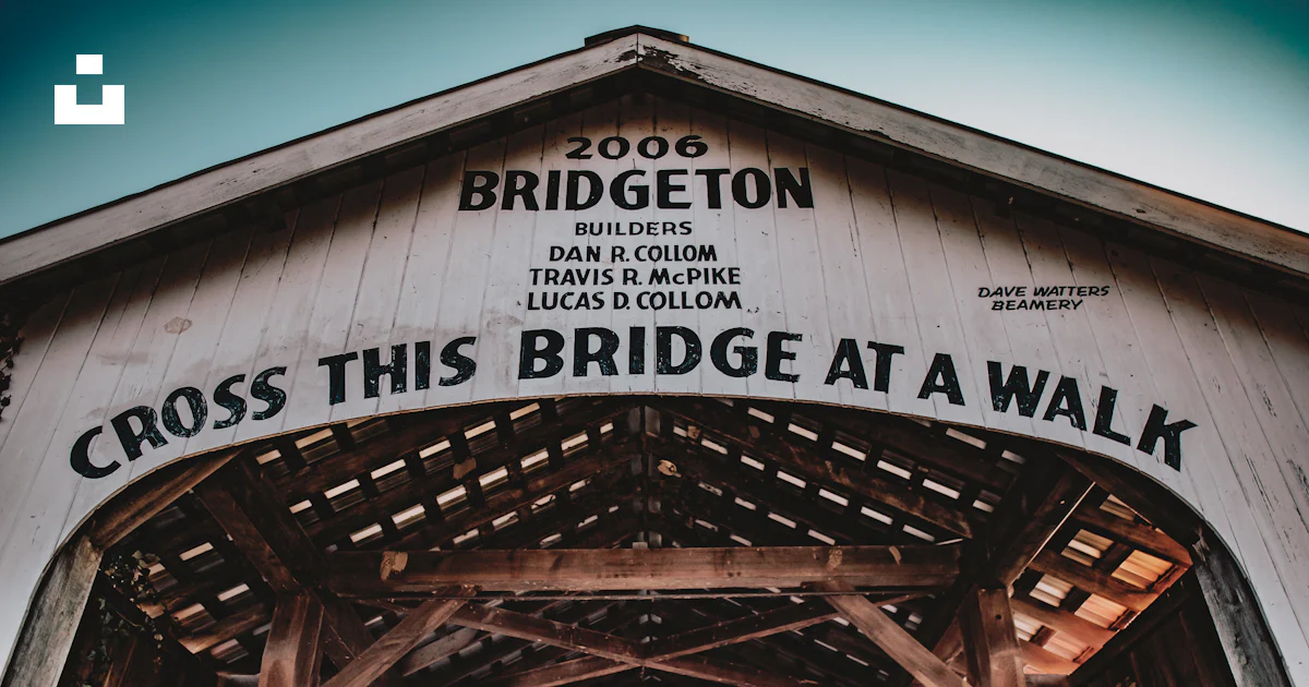 A wooden bridge with a sign that says cross this bridge at a walk photo ...
