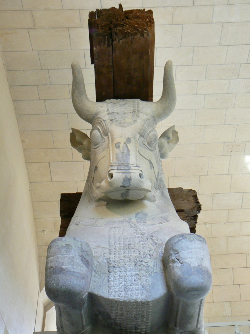 a statue of a bull sitting on a bench