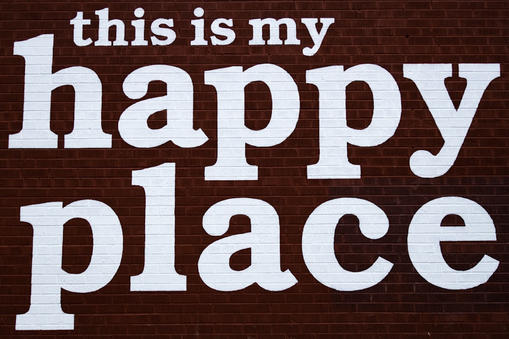 this is my happy place sign painted on a brick wall