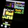 A blurred image showing a laptop screen with various programming-related words such as 'Node', 'JavaScript', 'Redis', and 'SQL'. The text appears in different colors and sizes, overlaid on the screen.