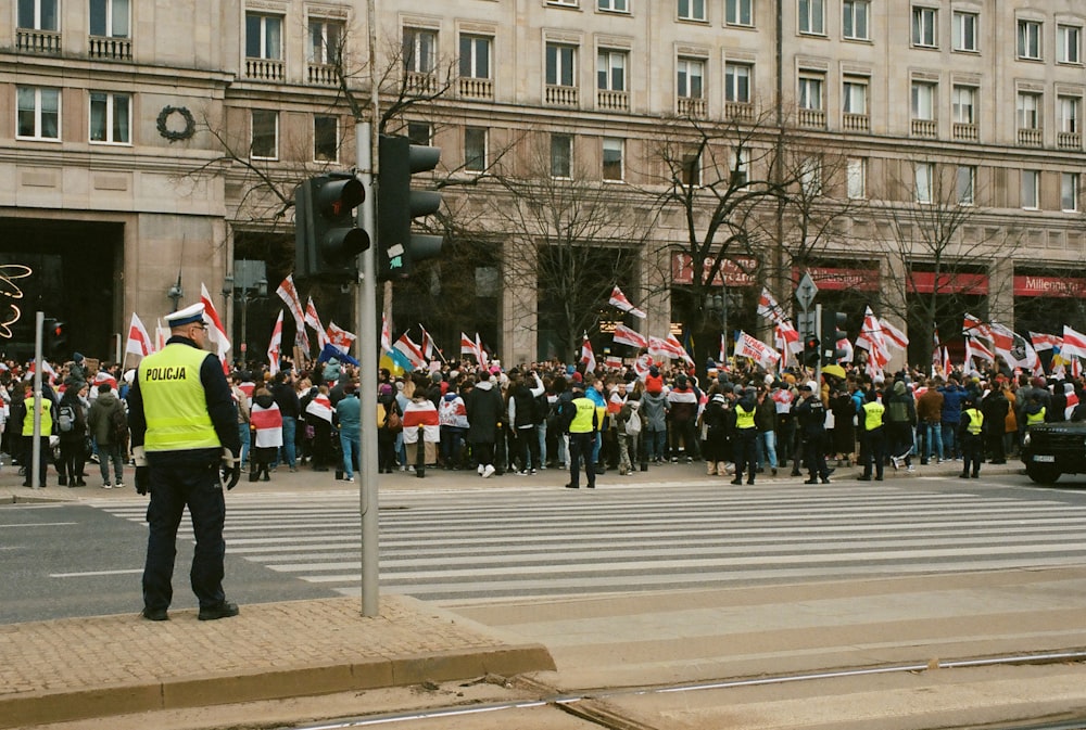 a group of people standing on the side of a road