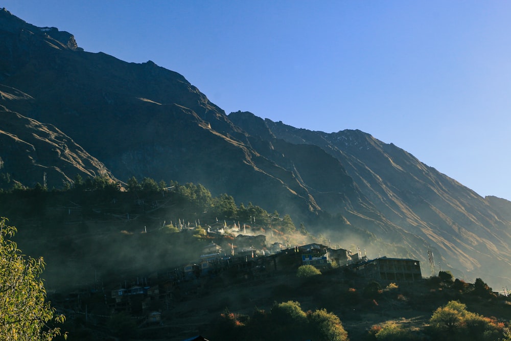 a view of a mountain with a village in the foreground