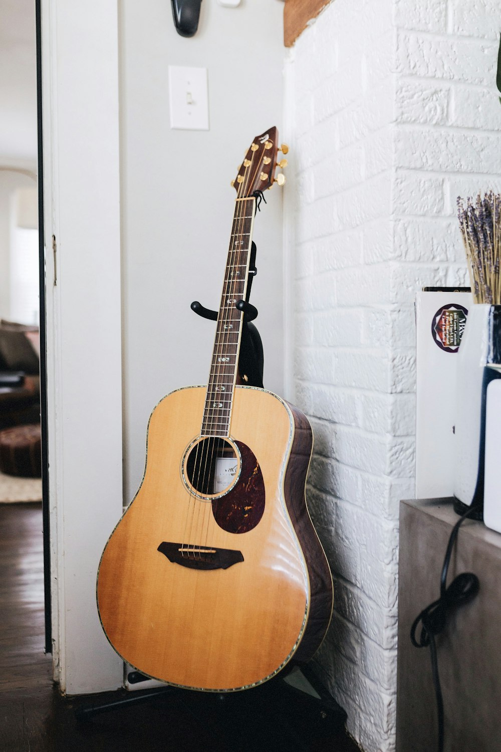 a guitar is propped up against the wall