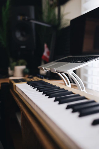 a keyboard with a laptop on top of it