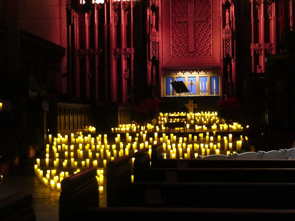 a church filled with lots of lit candles