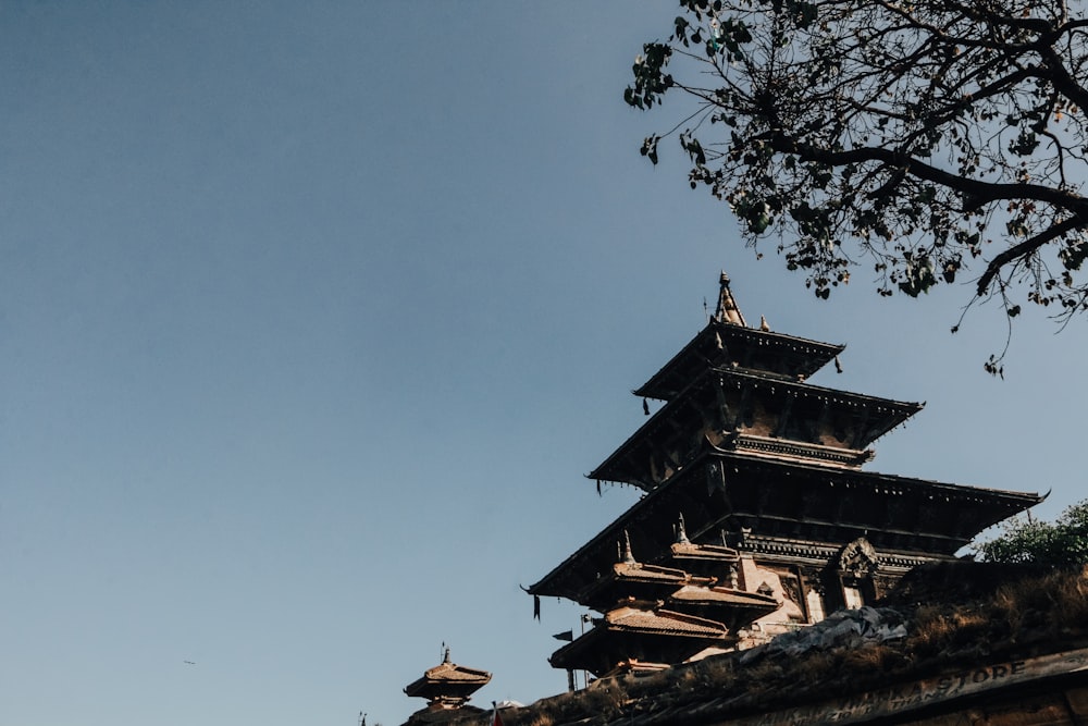 a tall wooden structure sitting on top of a lush green field