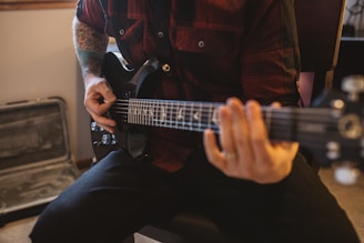 a man playing a guitar in a room