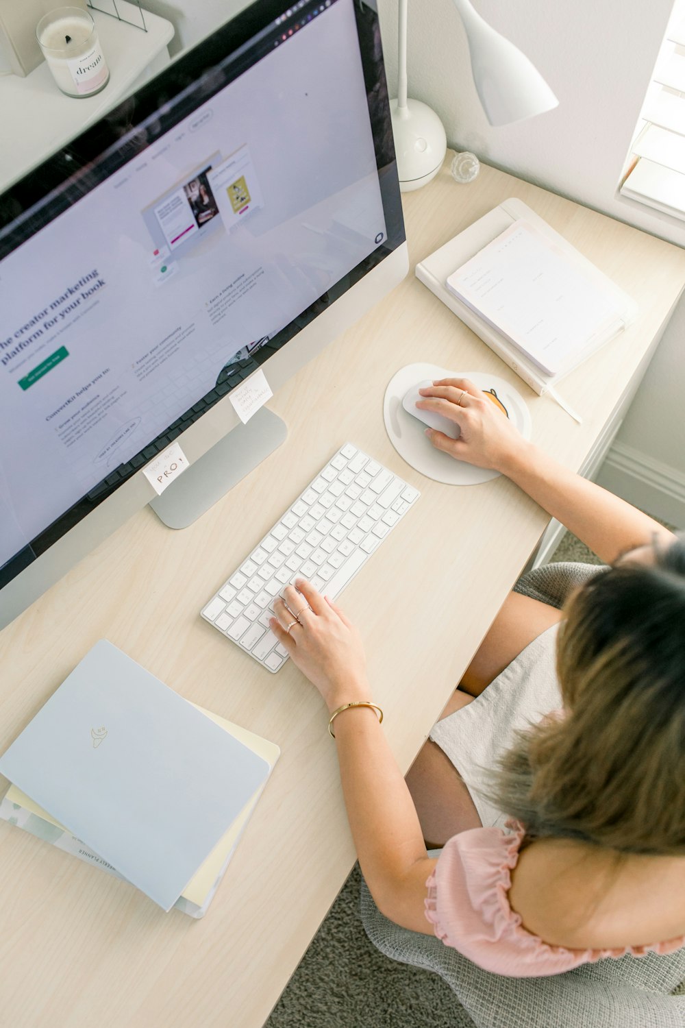 a woman sitting at a desk using a computer