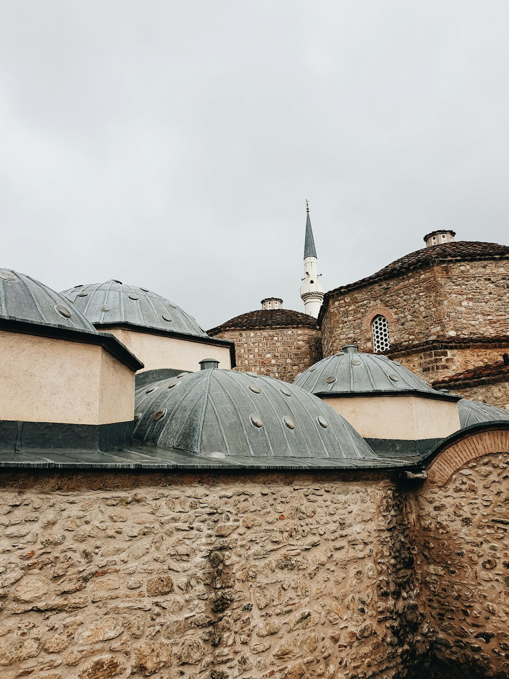 a stone building with a clock tower in the background