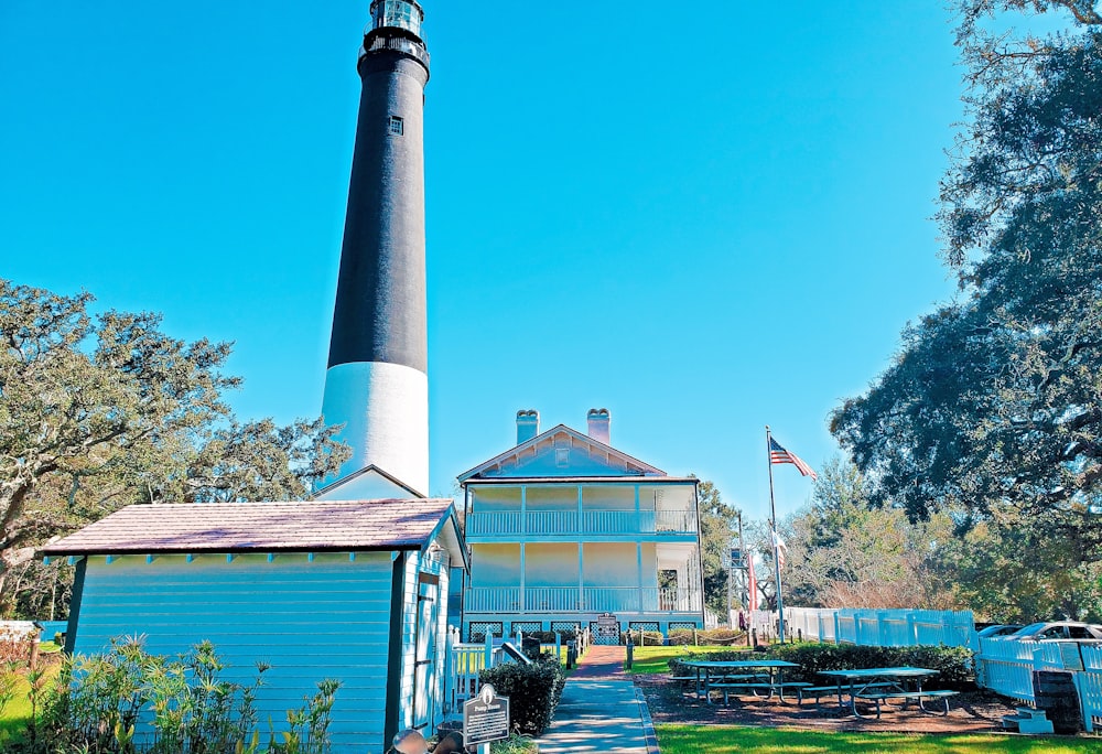 a light house sitting next to a picnic table