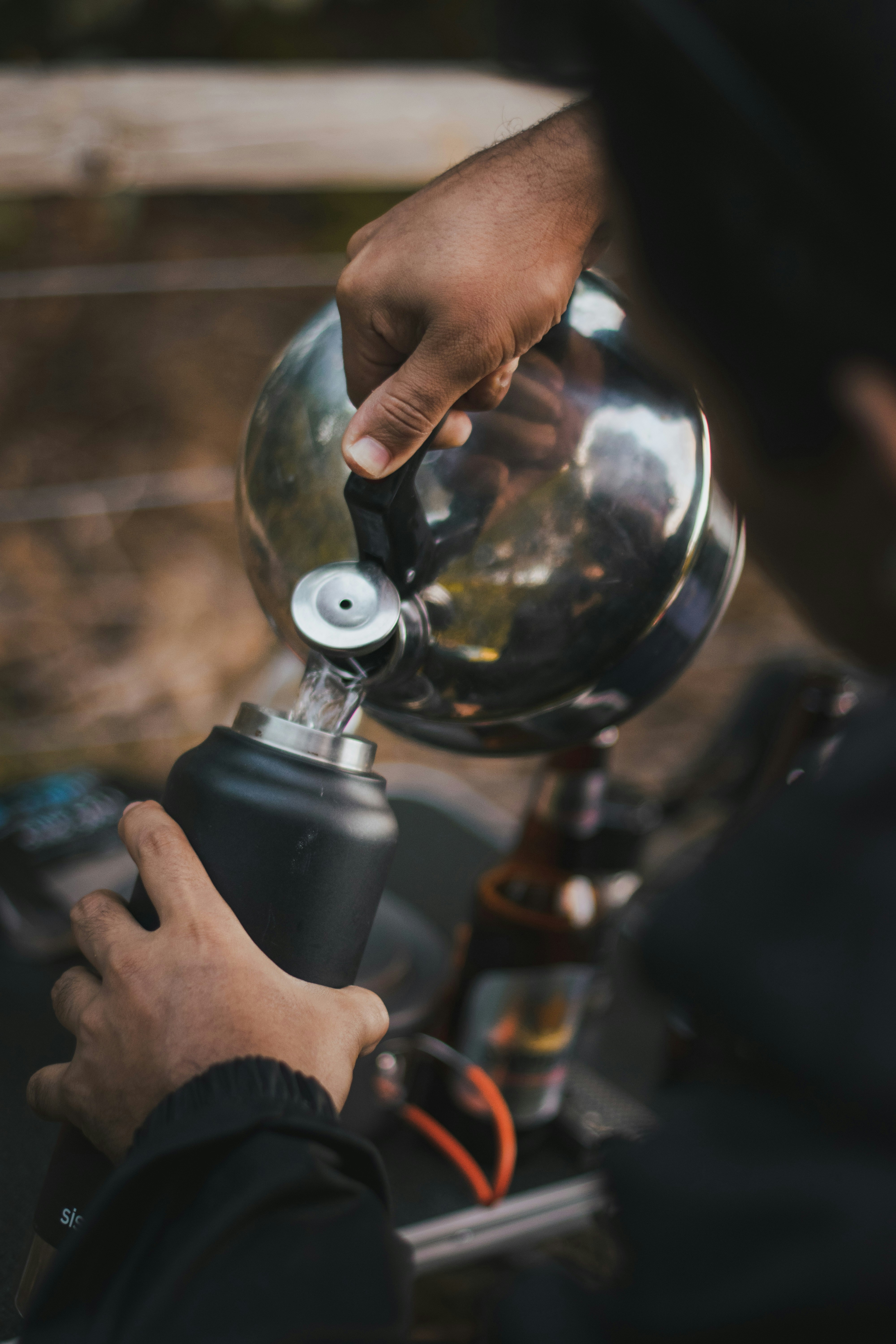 a person is pouring something into a coffee pot
