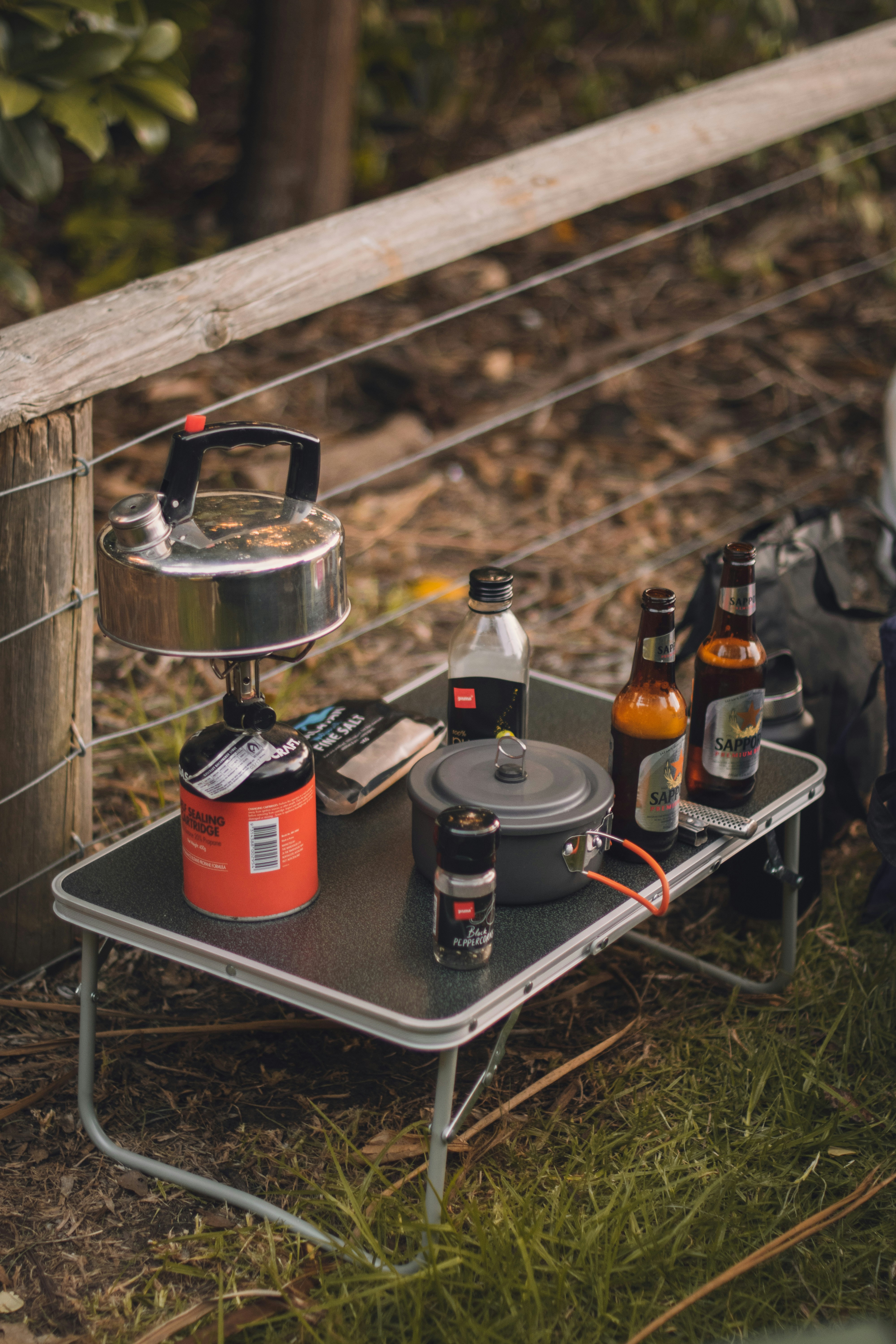 a camping table with a pot and pan on it