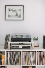 A minimalist dark-themed studio space with subtle gold accents and vintage vinyl records neatly arranged.