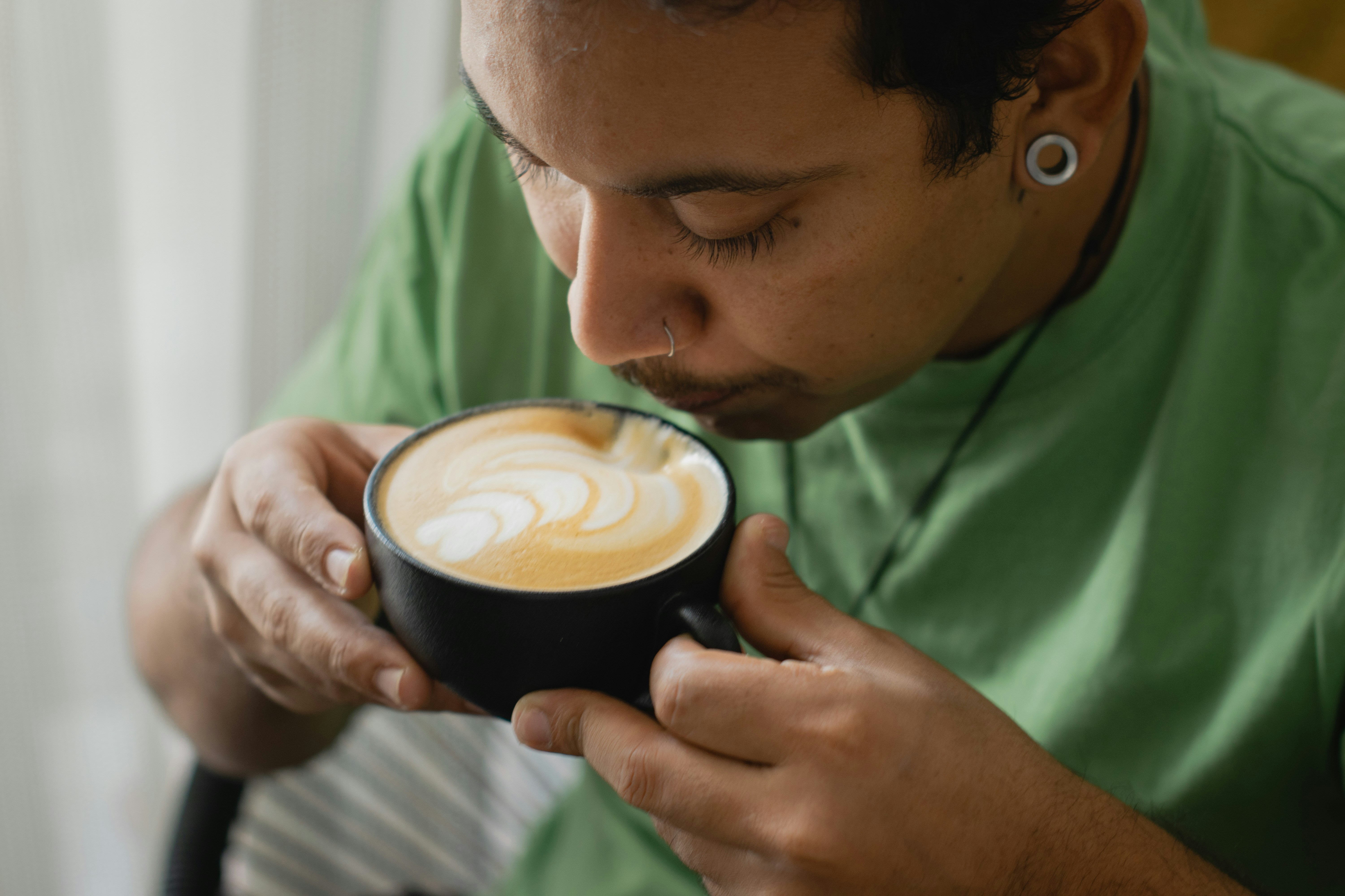 a man is holding a cup of coffee
