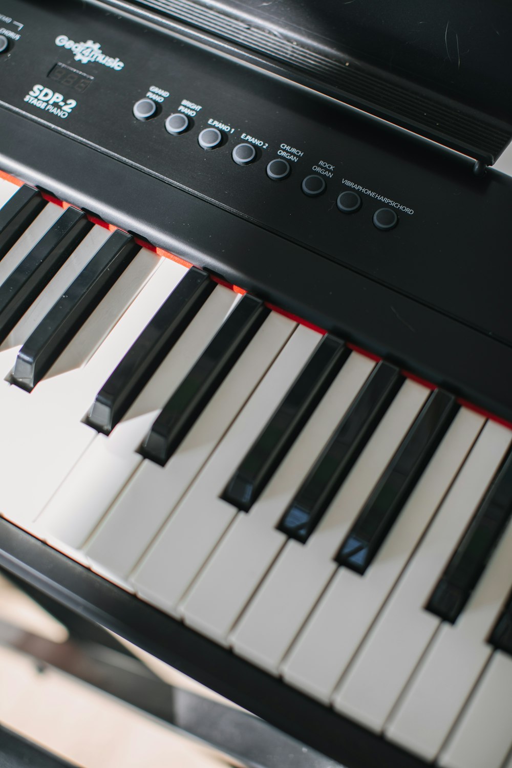 a close up of a piano keyboard with black keys