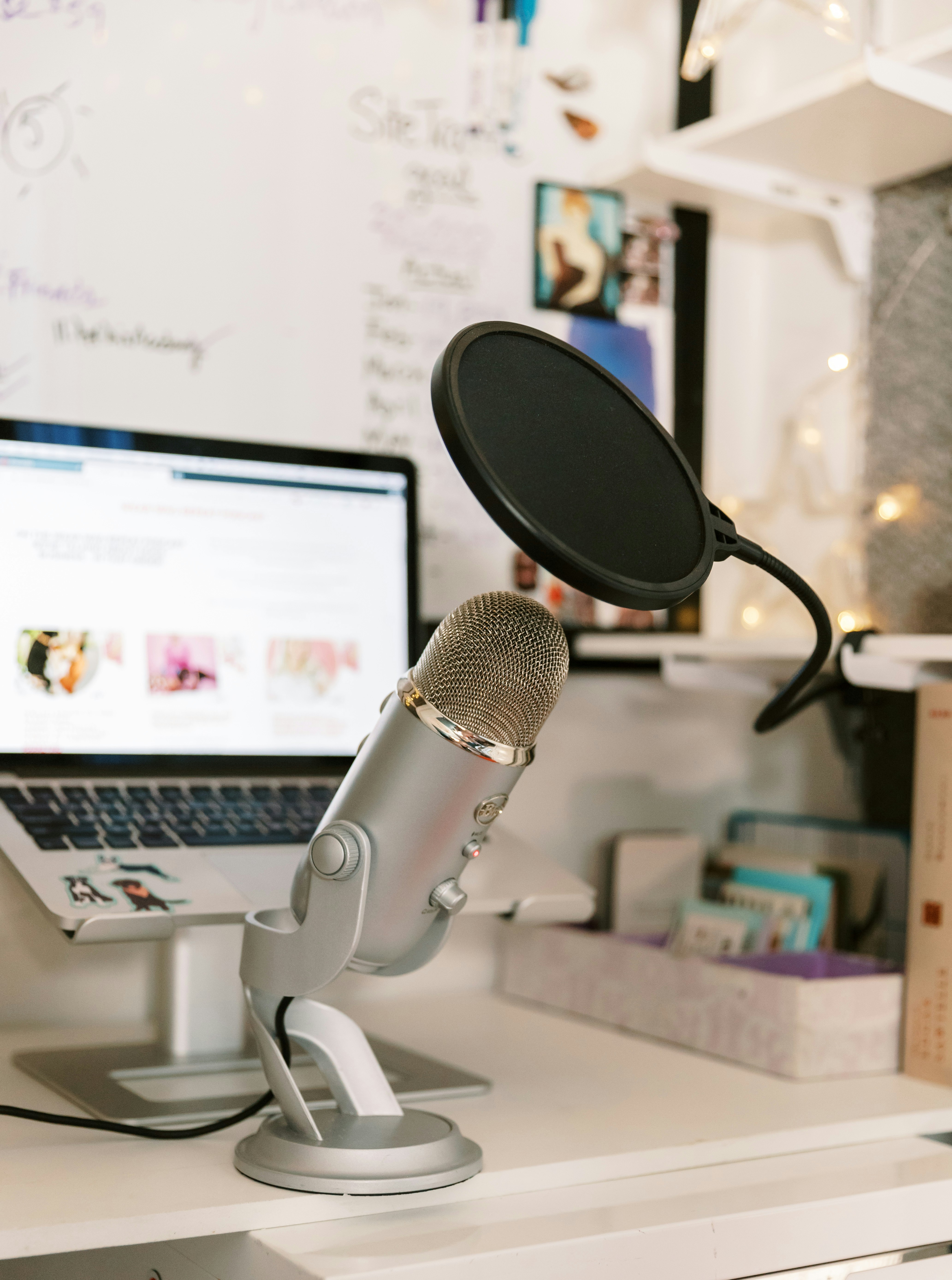 Sleek silver laptop on clean white desk, bright airy studio lighting