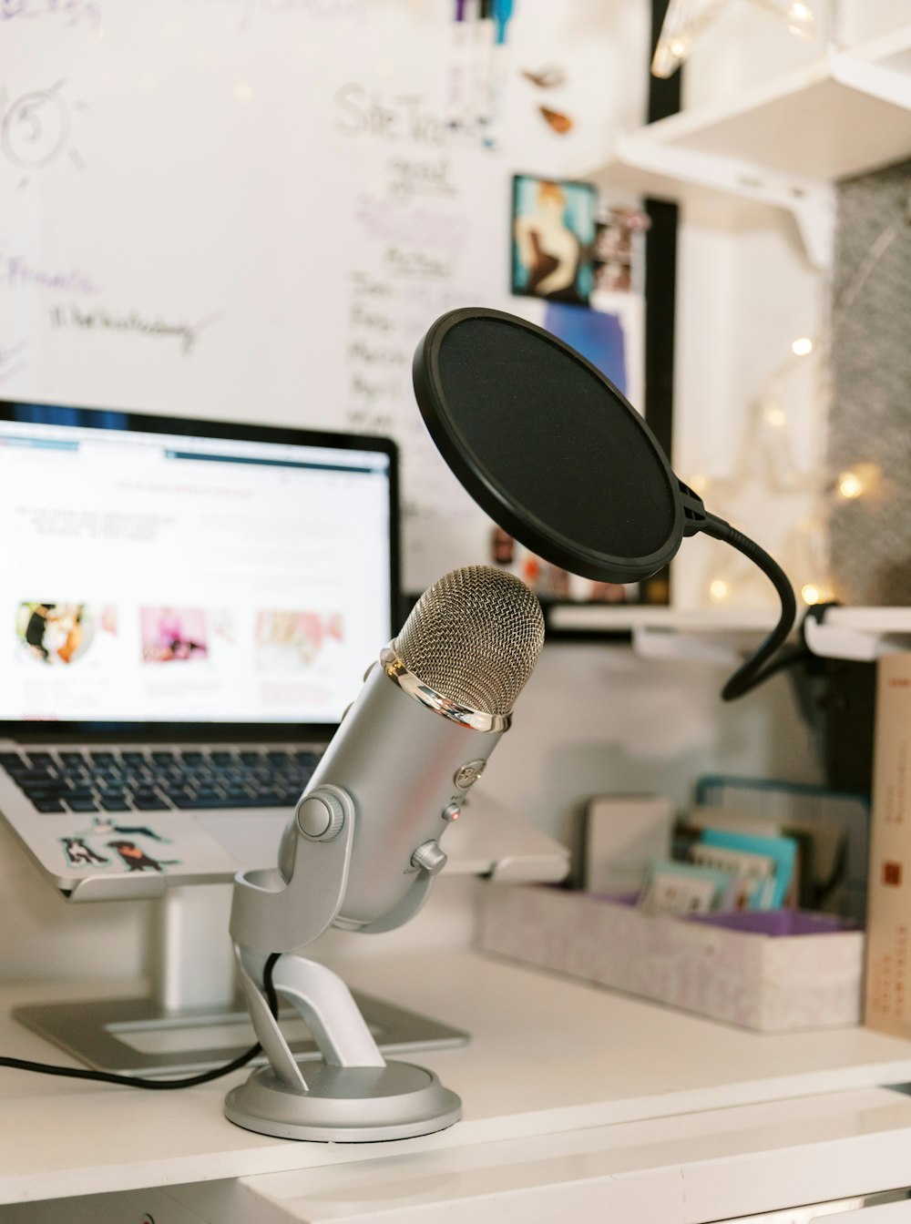 a microphone sitting on top of a desk next to a laptop