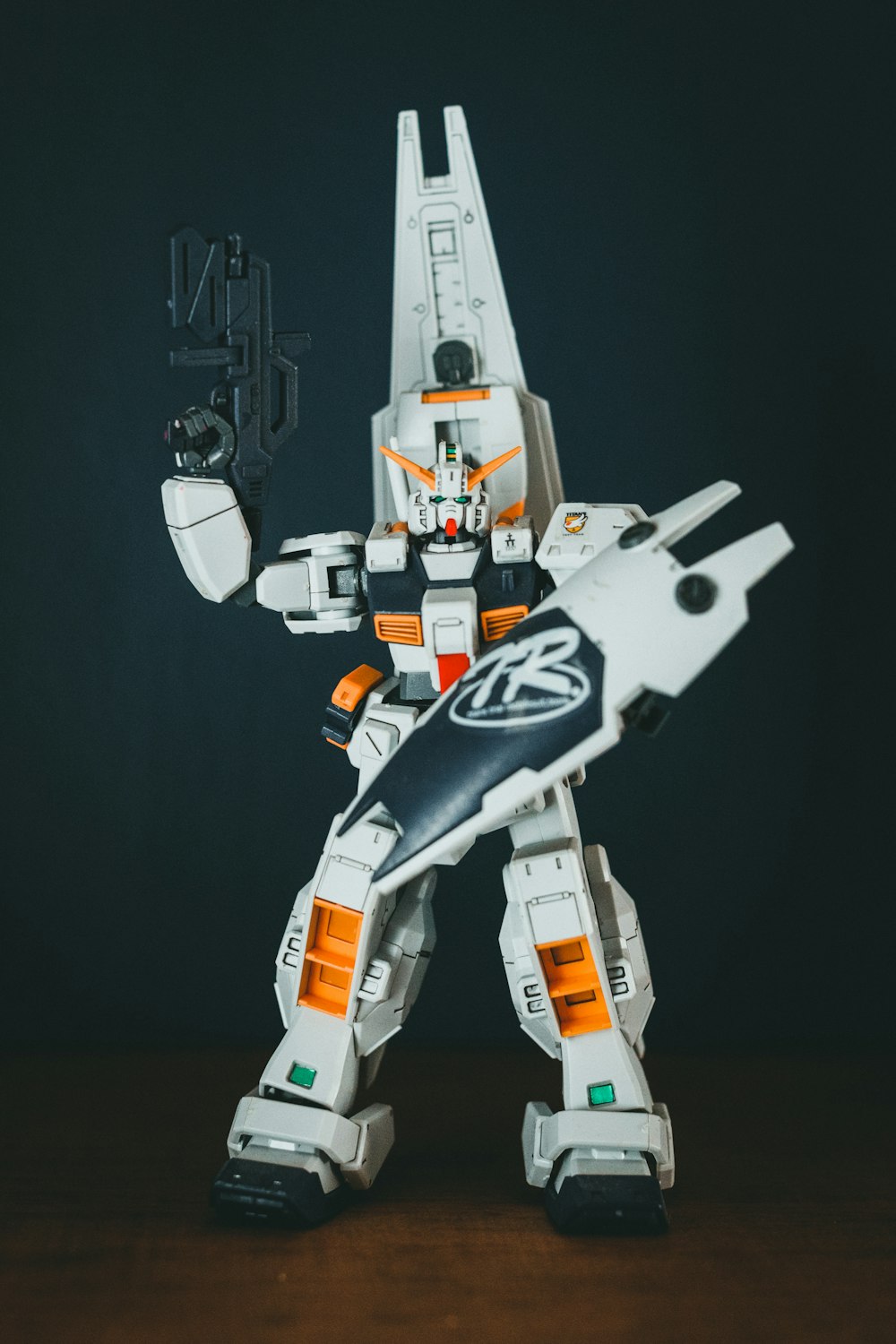 a white and orange robot with a gun