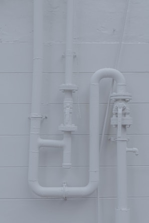Clean and organized pipework behind an indoor heating system.